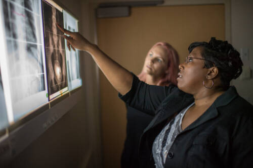 program director points out radiation x-rays to a student
